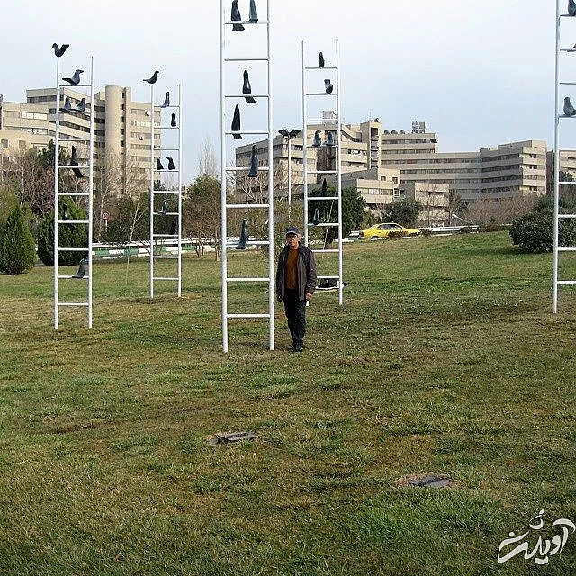 علی داوری در کنار اثرش با عنوان داستان کلاغ ها